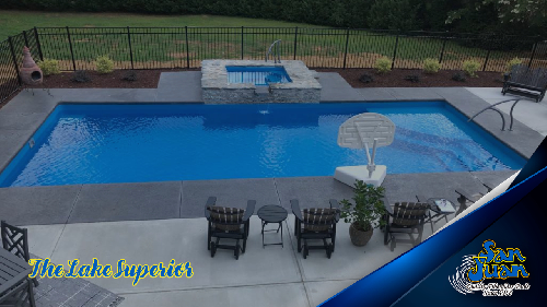 Lake Superior pool from San Juan Pools, with a spa on the far side and chairs on the near side and a basketball pool hoop